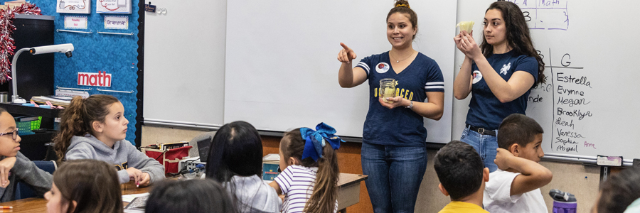 Student teachers working in classroom with young students.